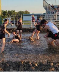 FFA members play in mud volleyball
